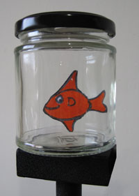 A little cut out goldfish in a jam jar Small card fish swimming in a jar