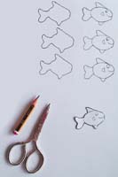 Cut out some fishes from a piece of thin card Small card fishes swimming in an apple box aquarium