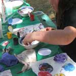 Making marbled paper discs using small bowls of thickened water and oil paints.